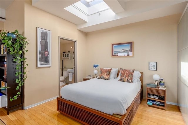 156 Porter St Unit 434, Boston, MA 02128 - bedroom featuring a skylight, light wood-style floors, and connected bathroom