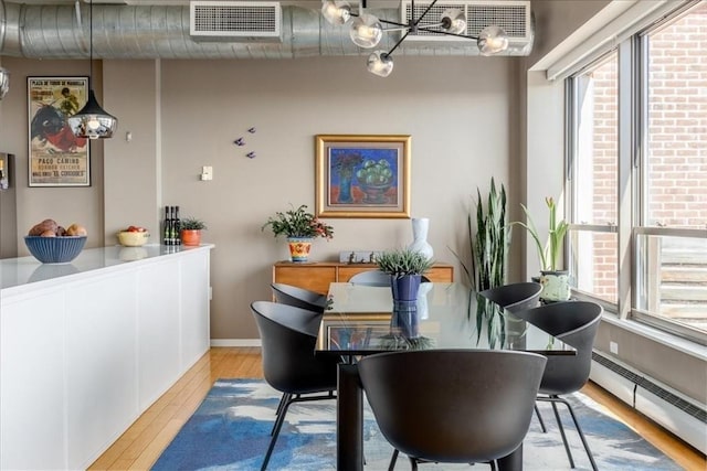 156 Porter St Unit 434, Boston, MA 02128 - dining space with a baseboard heating unit and wood finished floors