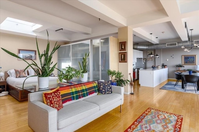 156 Porter St Unit 434, Boston, MA 02128 - living room with beamed ceiling, light wood-type flooring, and a skylight