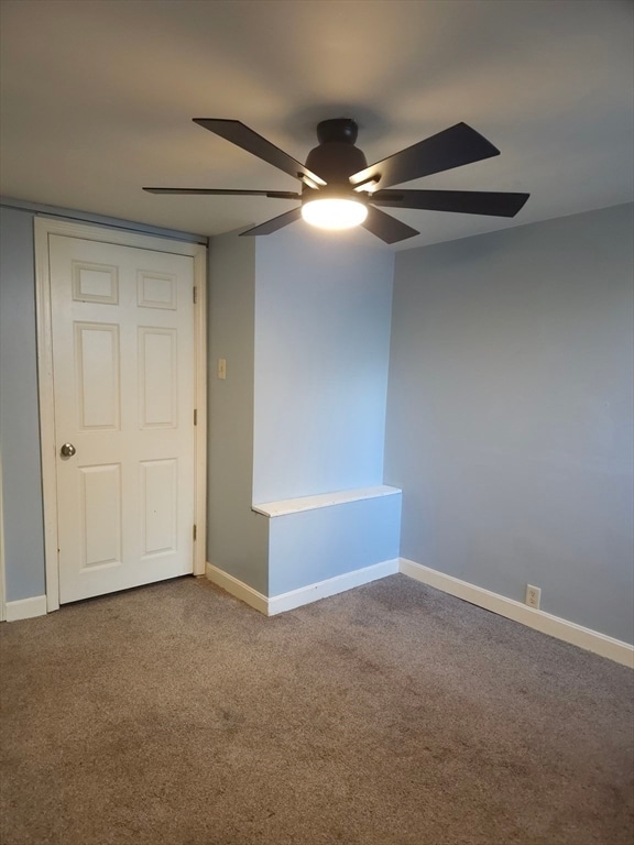 empty room with carpet flooring and ceiling fan