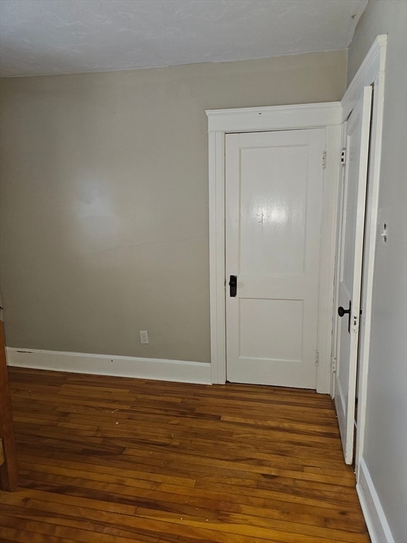 empty room featuring dark wood-type flooring