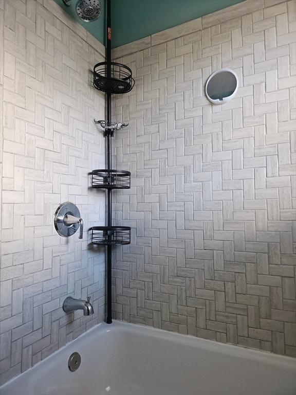 bathroom with tiled shower / bath combo