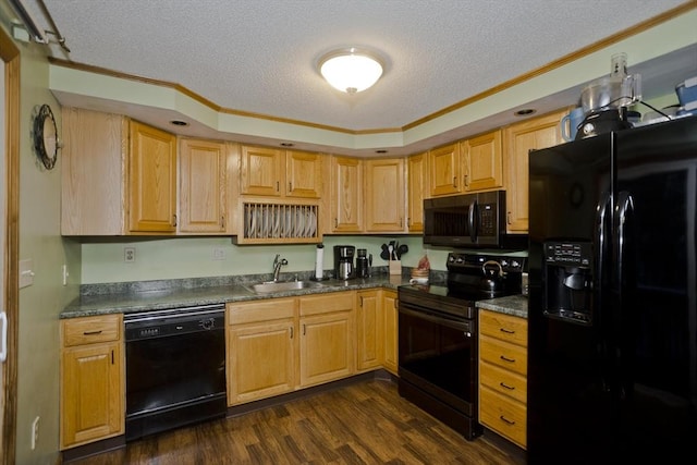 kitchen featuring sink, black appliances, dark hardwood / wood-style floors, and a textured ceiling