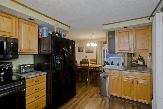 kitchen with pendant lighting, dark wood-type flooring, black appliances, and a textured ceiling