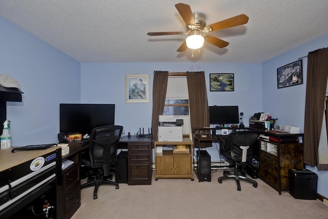 carpeted home office featuring ceiling fan and a textured ceiling