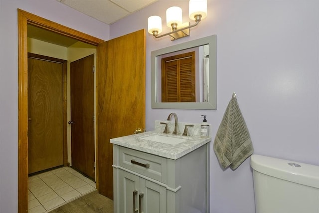 bathroom featuring vanity, tile patterned floors, and toilet