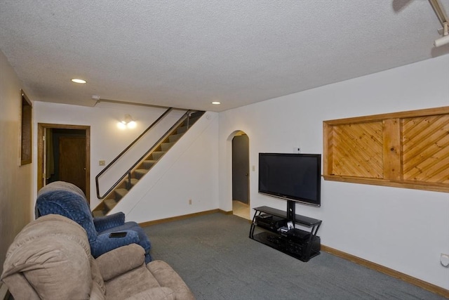 living room with carpet flooring and a textured ceiling