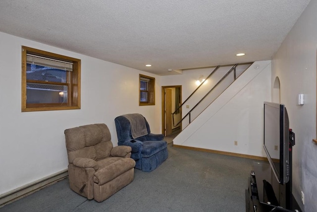 living area with a textured ceiling and carpet flooring