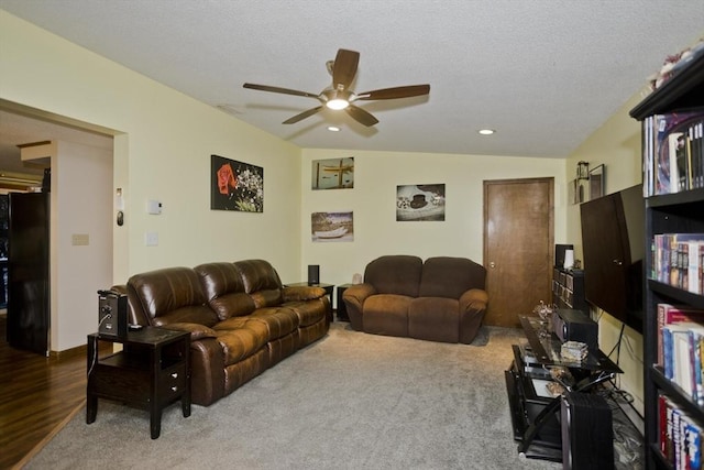 living room featuring hardwood / wood-style floors, a textured ceiling, and ceiling fan