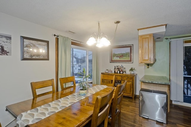 dining area with dark hardwood / wood-style floors and a notable chandelier