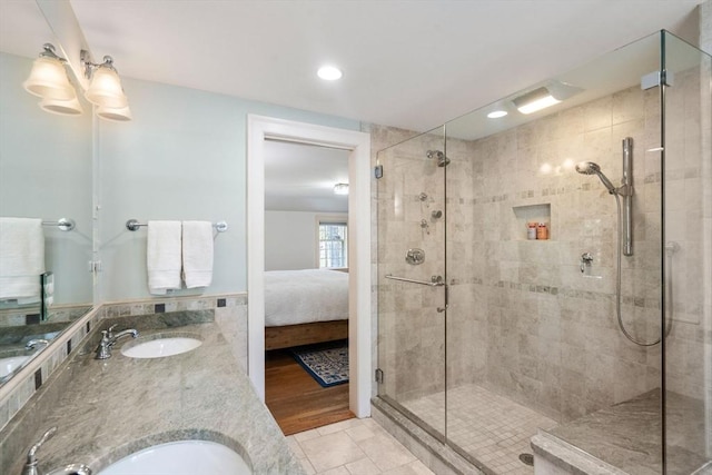 full bathroom featuring a sink, tile patterned floors, a shower stall, and connected bathroom