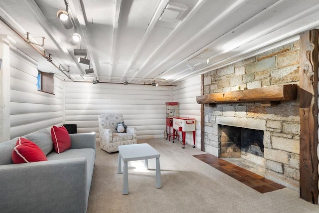 carpeted living room with a stone fireplace