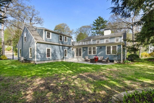 back of property featuring an outdoor living space, a yard, and a patio