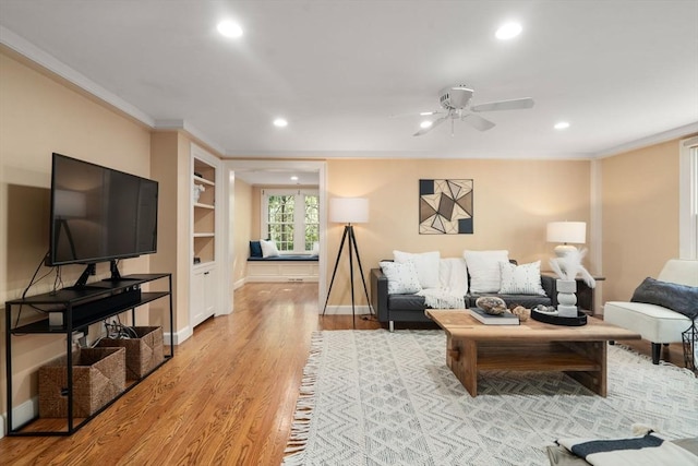 living room with recessed lighting, a ceiling fan, ornamental molding, and light wood finished floors