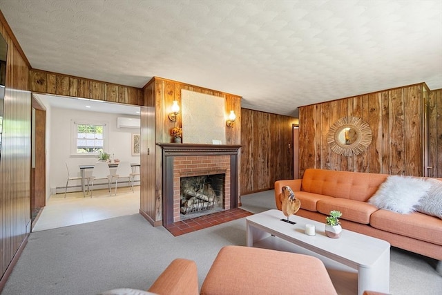 481 W Townsend Rd, Lunenburg, MA 01462 - living area featuring wood walls, a fireplace, a textured ceiling, a baseboard radiator, and a wall unit AC