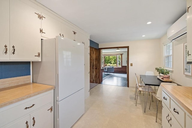 481 W Townsend Rd, Lunenburg, MA 01462 - kitchen featuring light countertops, freestanding refrigerator, white cabinetry, light flooring, and recessed lighting