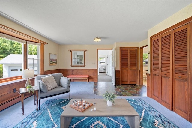 481 W Townsend Rd, Lunenburg, MA 01462 - living room featuring a wainscoted wall and a textured ceiling