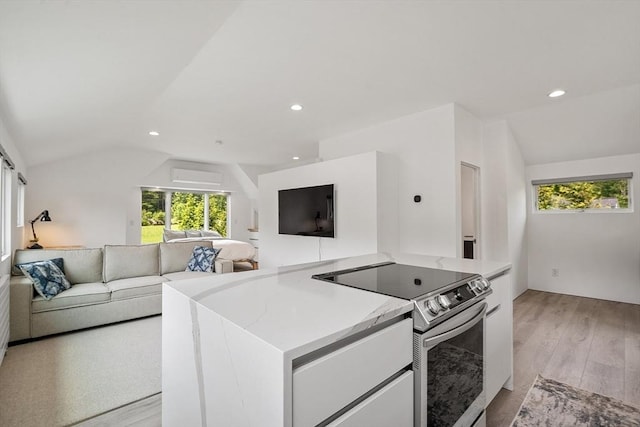 481 W Townsend Rd, Lunenburg, MA 01462 - kitchen featuring stainless steel electric stove, lofted ceiling, open floor plan, plenty of natural light, and light wood-style flooring