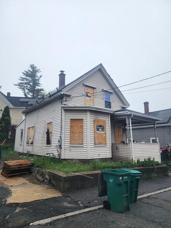 shotgun-style home featuring a chimney
