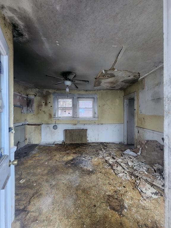 misc room with radiator and ceiling fan