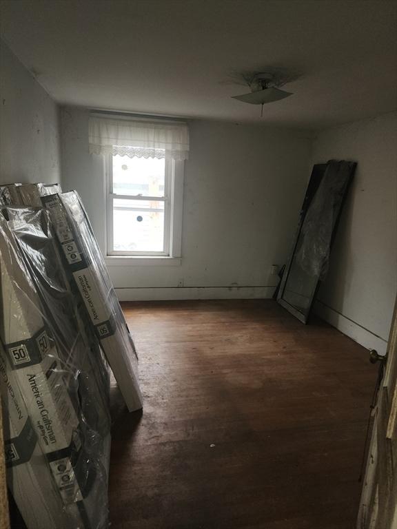 spare room featuring wood finished floors