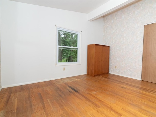10 Ash Ln, Sherborn, MA 01770 - empty room featuring wood finished floors, baseboards, and wallpapered walls