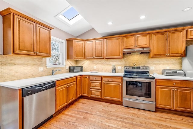 50 Walnut St, Lynn, MA 01905 - kitchen featuring appliances with stainless steel finishes, a skylight, under cabinet range hood, a sink, and lofted ceiling