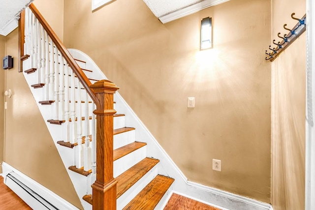 50 Walnut St, Lynn, MA 01905 - stairs featuring a baseboard radiator, wood finished floors, and baseboards