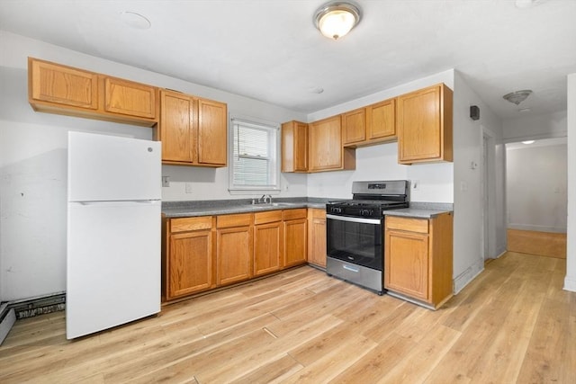 36 Brookford St, Boston, MA 02125 - kitchen with freestanding refrigerator, stainless steel gas stove, light wood finished floors, and a sink