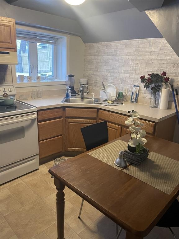 kitchen featuring a sink, light countertops, exhaust hood, and white electric stove