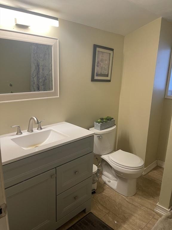 bathroom featuring toilet and vanity