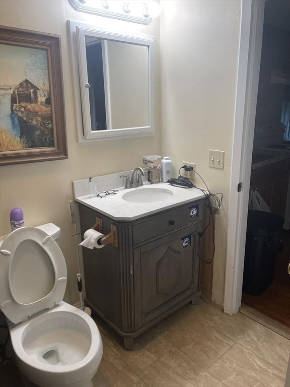 half bathroom with toilet and vanity