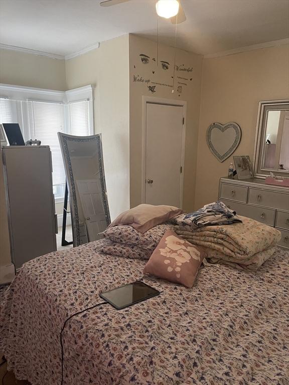 bedroom featuring crown molding and ceiling fan