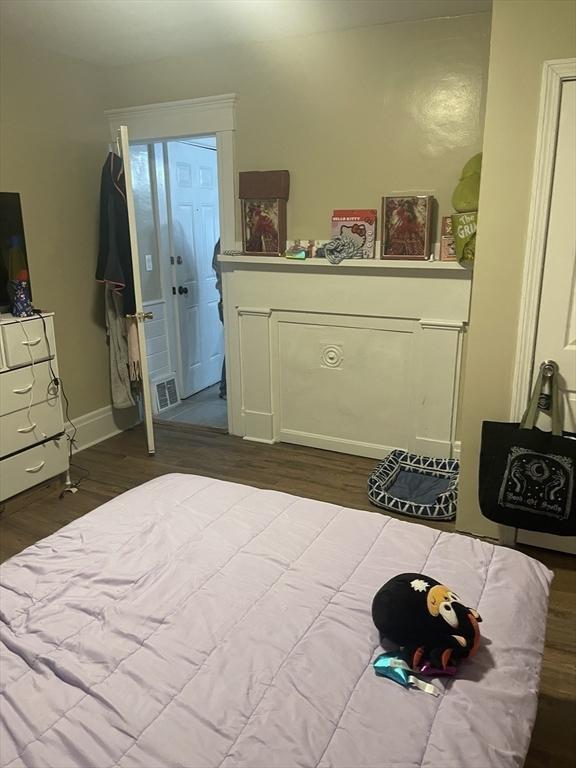 bedroom with visible vents and wood finished floors