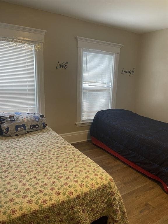 bedroom featuring baseboards and wood finished floors