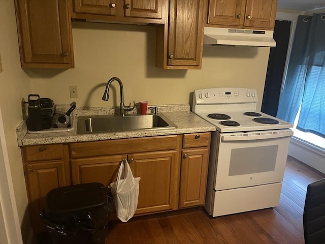 kitchen with under cabinet range hood, a sink, white range with electric stovetop, light countertops, and dark wood-style flooring