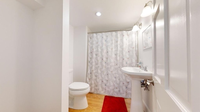 52 Sanborn St Unit 408, Reading, MA 01867 - bathroom featuring wood finished floors, curtained shower, and toilet