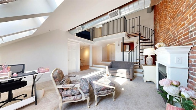 52 Sanborn St Unit 408, Reading, MA 01867 - living room featuring stairs, a skylight, brick wall, carpet floors, and visible vents