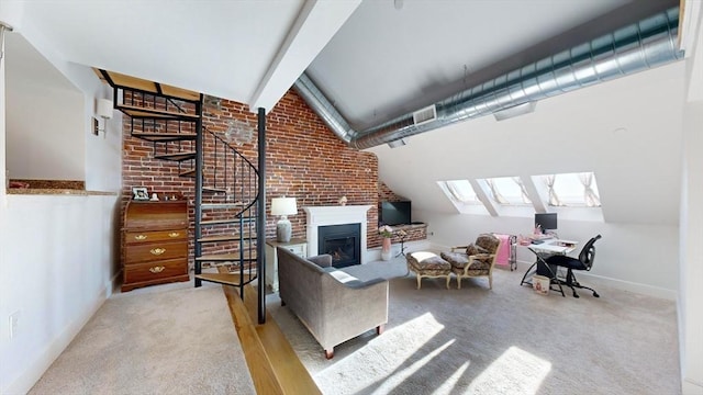 52 Sanborn St Unit 408, Reading, MA 01867 - carpeted living area featuring stairway, a glass covered fireplace, vaulted ceiling with beams, brick wall, and baseboards