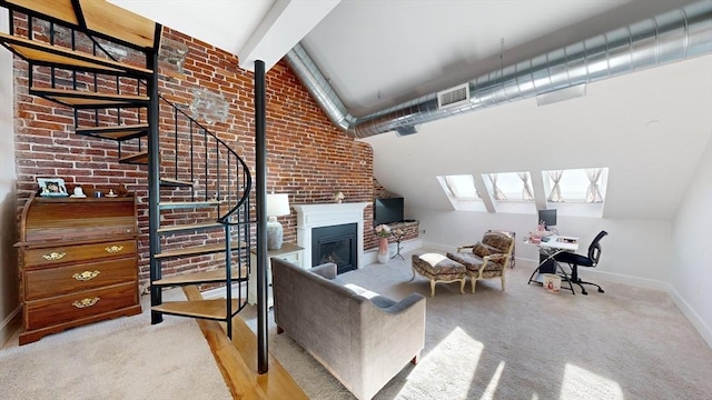 52 Sanborn St Unit 408, Reading, MA 01867 - carpeted living area featuring visible vents, baseboards, lofted ceiling with beams, a glass covered fireplace, and brick wall