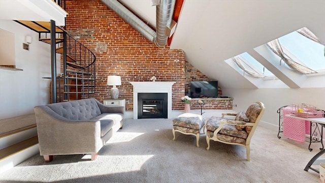 52 Sanborn St Unit 408, Reading, MA 01867 - carpeted living room featuring vaulted ceiling with skylight, a glass covered fireplace, and brick wall