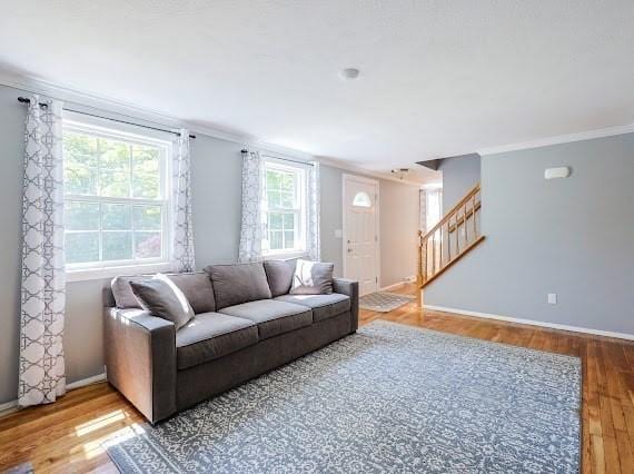 230 2nd St, Stoughton, MA 02072 - living area with light wood-style floors, stairs, ornamental molding, and baseboards
