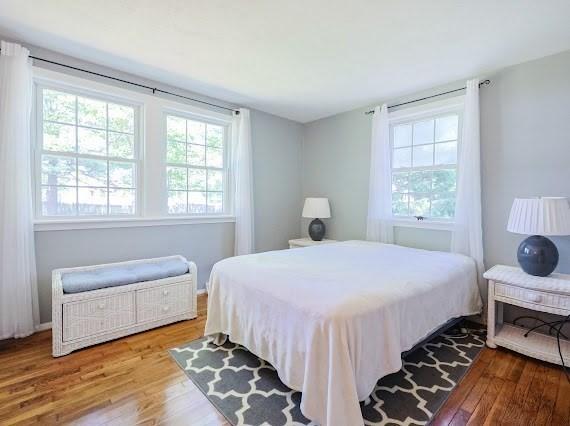 230 2nd St, Stoughton, MA 02072 - bedroom featuring multiple windows and wood finished floors