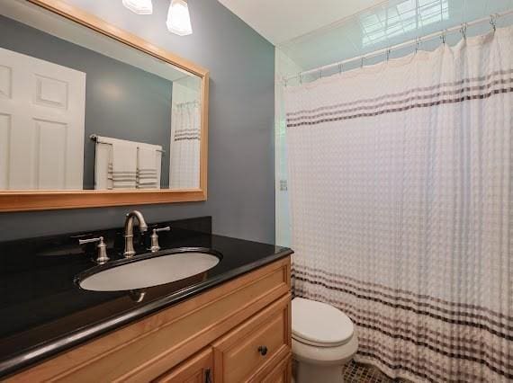 230 2nd St, Stoughton, MA 02072 - bathroom featuring vanity, toilet, and curtained shower