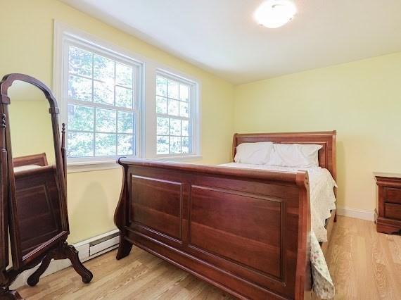 230 2nd St, Stoughton, MA 02072 - bedroom featuring a baseboard radiator, light wood finished floors, and multiple windows