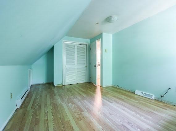 230 2nd St, Stoughton, MA 02072 - bonus room featuring a baseboard heating unit, wood finished floors, and vaulted ceiling