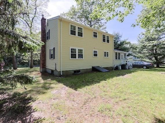 230 2nd St, Stoughton, MA 02072 - back of property featuring a chimney and a yard
