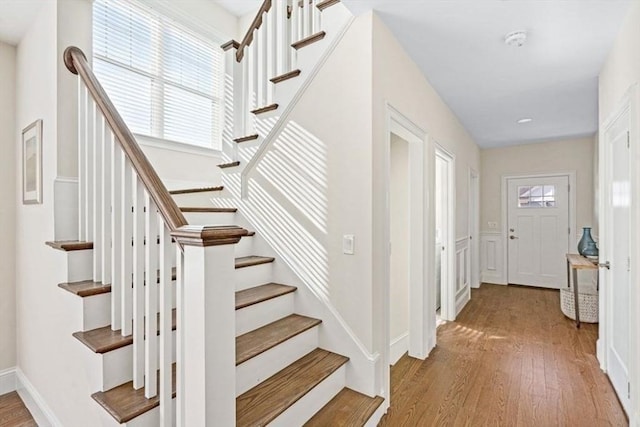 stairway with hardwood / wood-style flooring