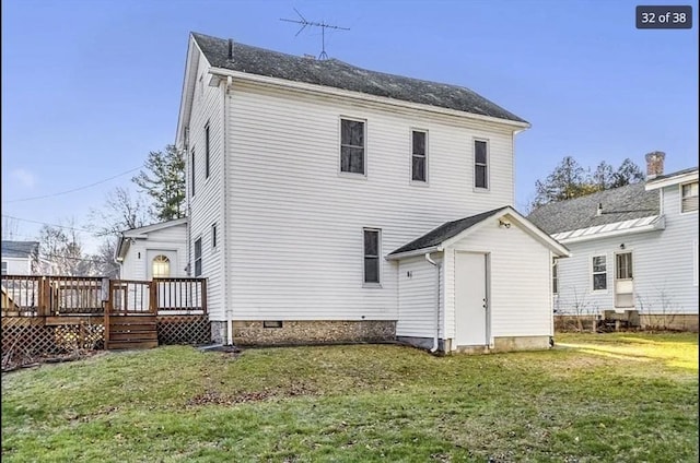 back of property featuring a yard and a wooden deck