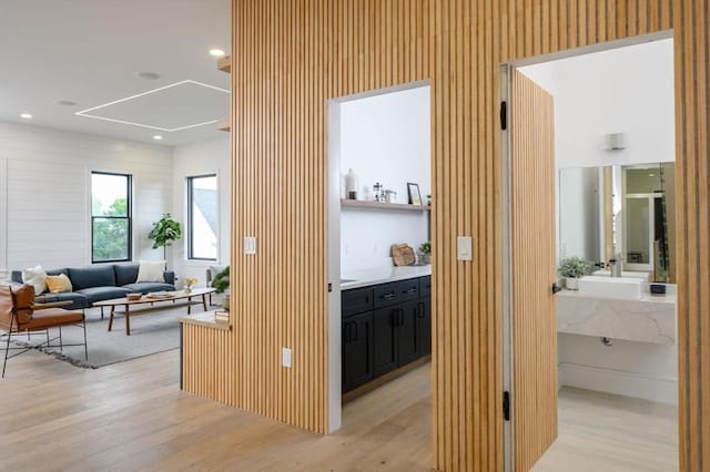 hall featuring light hardwood / wood-style floors and sink